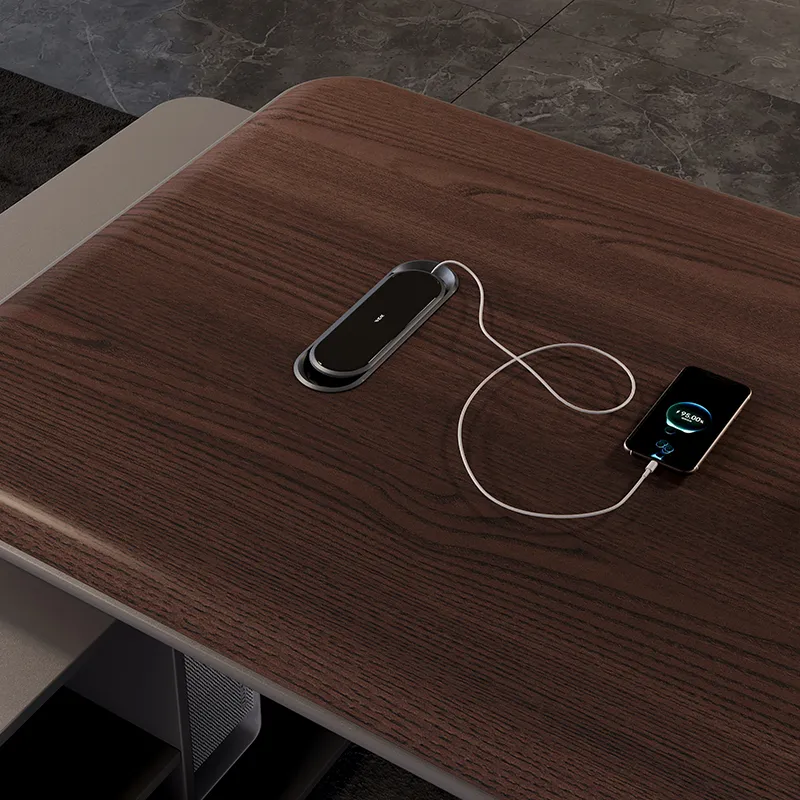 Hidden desktop power outlet integrated into modern manager office desk