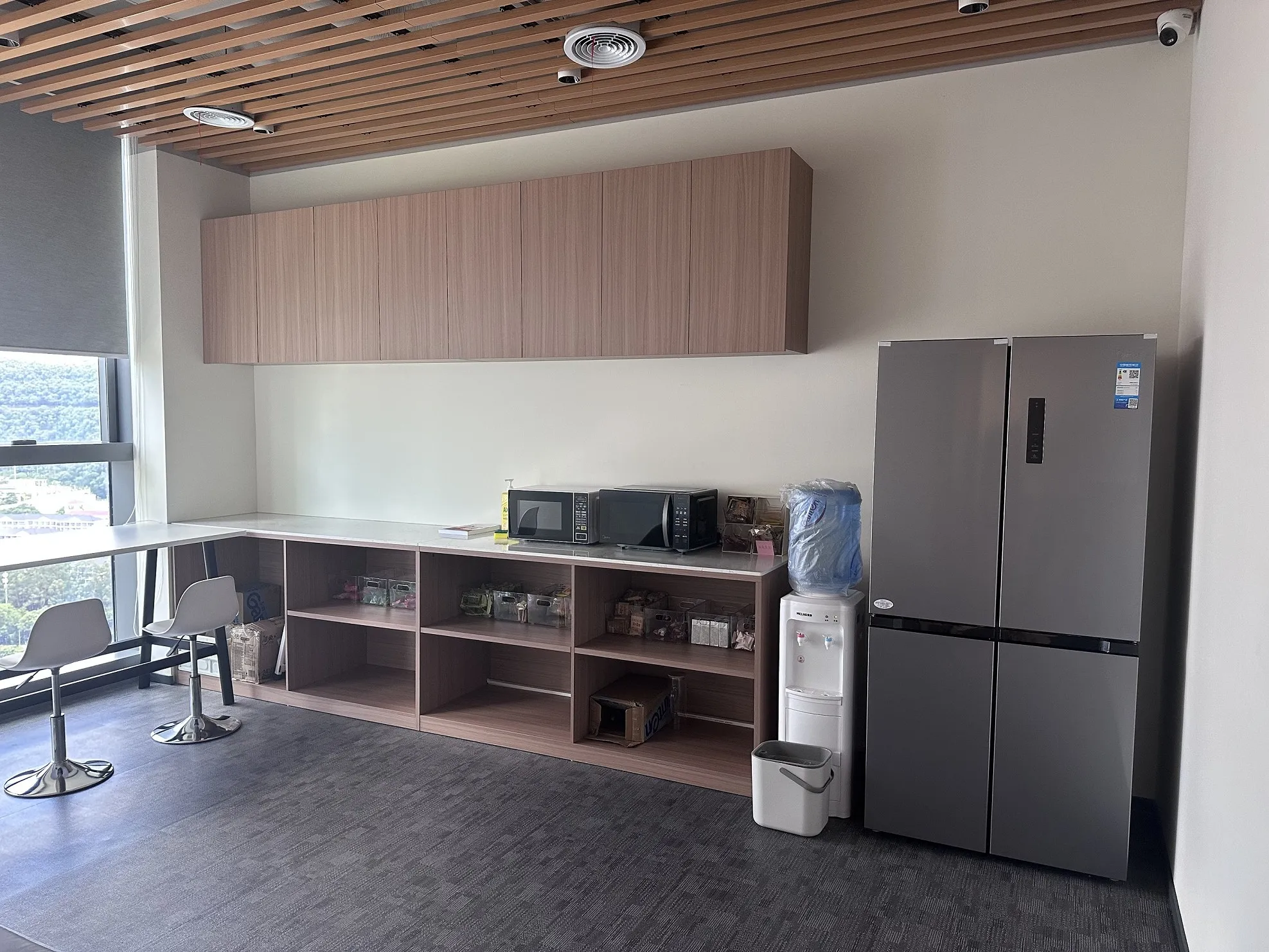Office pantry and employee lounge area with natural wood finishes